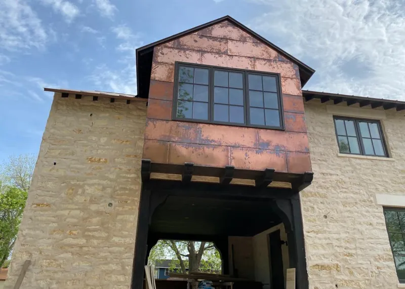 Copper metal panel facade on a stone building for Metal Roof Coating in Leland